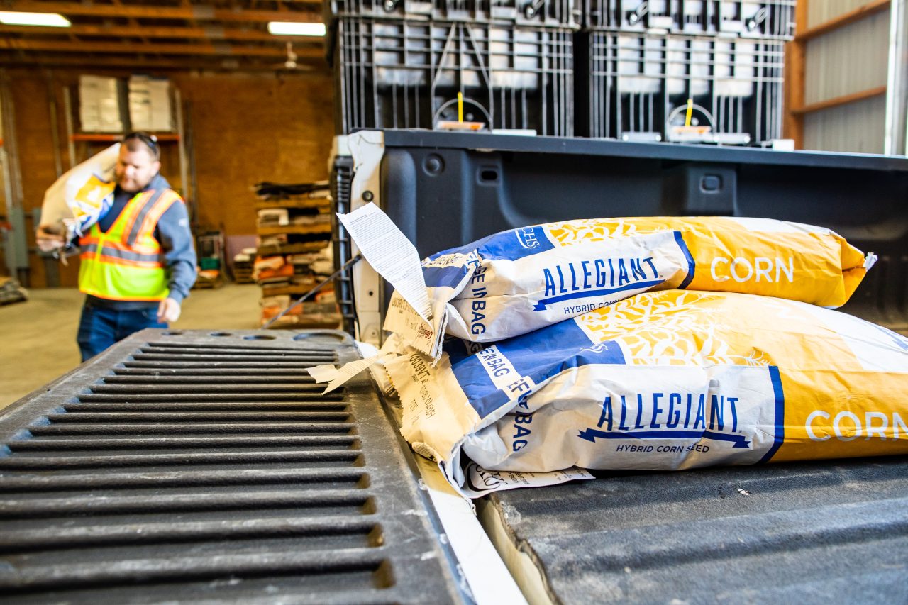 Allegiant Seed Corn bags sitting in the bed of a pickup truck
